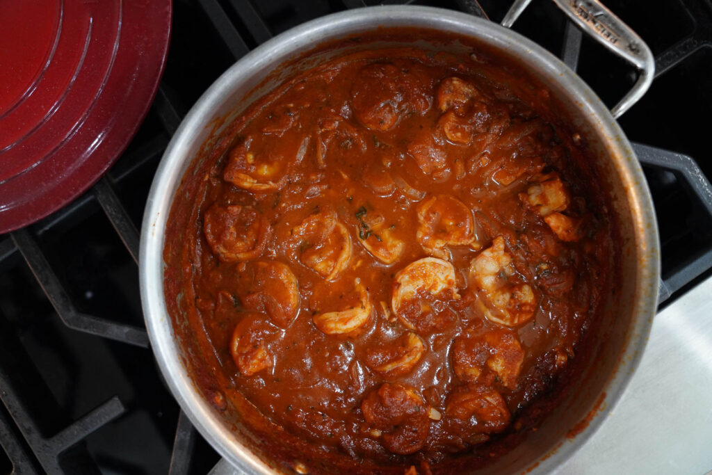 Sautéed shrimp in a saute pan in marinara sauce