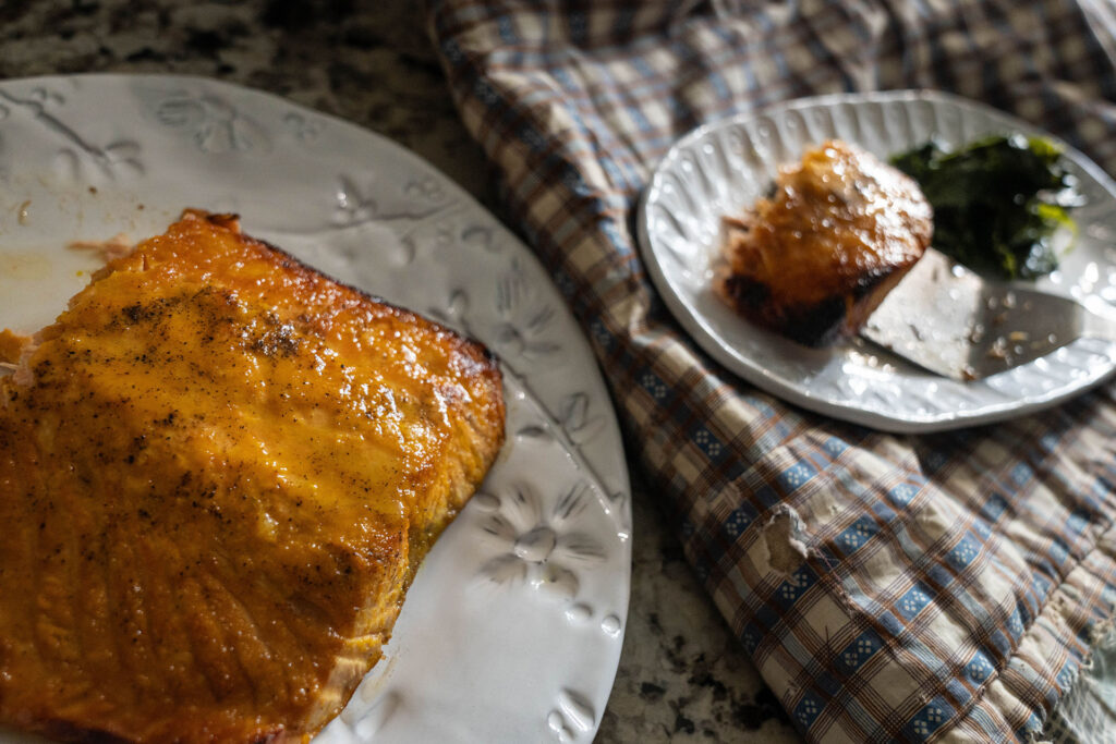 air fried salmon on a white place next to a side dish