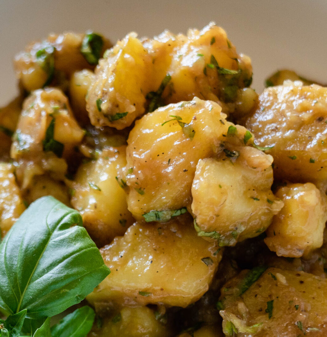 boiled potatoes mixed in a bowl with seasoning