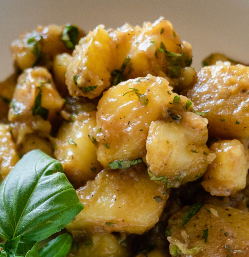 boiled potatoes mixed in a bowl with seasoning