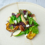 Delicata Squash Salad with Roasted Pecans and Apple Cider Vinaigrette on a serving plate