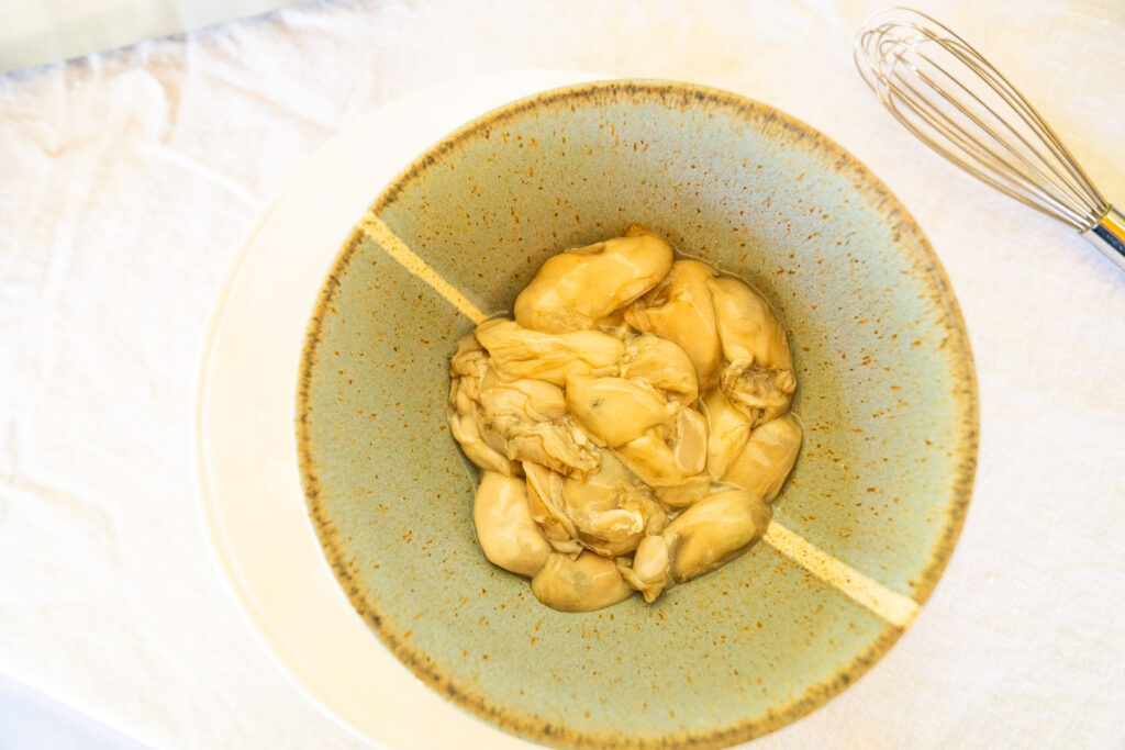 raw oysters in a prep bowl