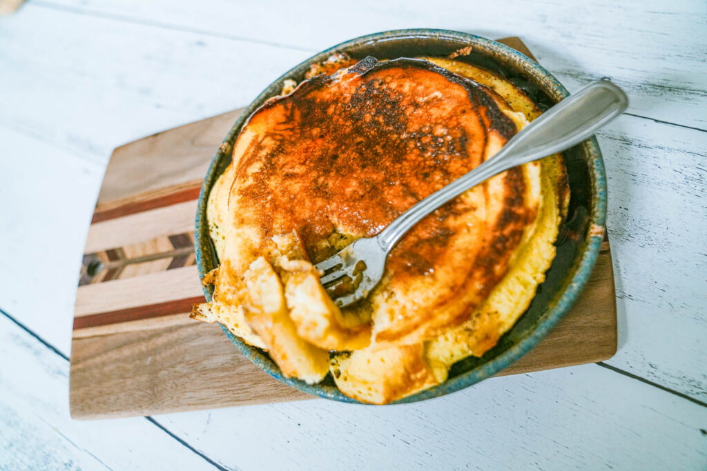 Brown butter pancakes on a beautiful serving dish and fork